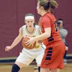 Photo by Joey Klecka/Peninsula Clarion Homer senior forward Madison Akers tracks the ball while defending Houston forward Aspen Ruth in Friday's semifinal game at the Southcentral Conference tournament at Grace Christian High School.