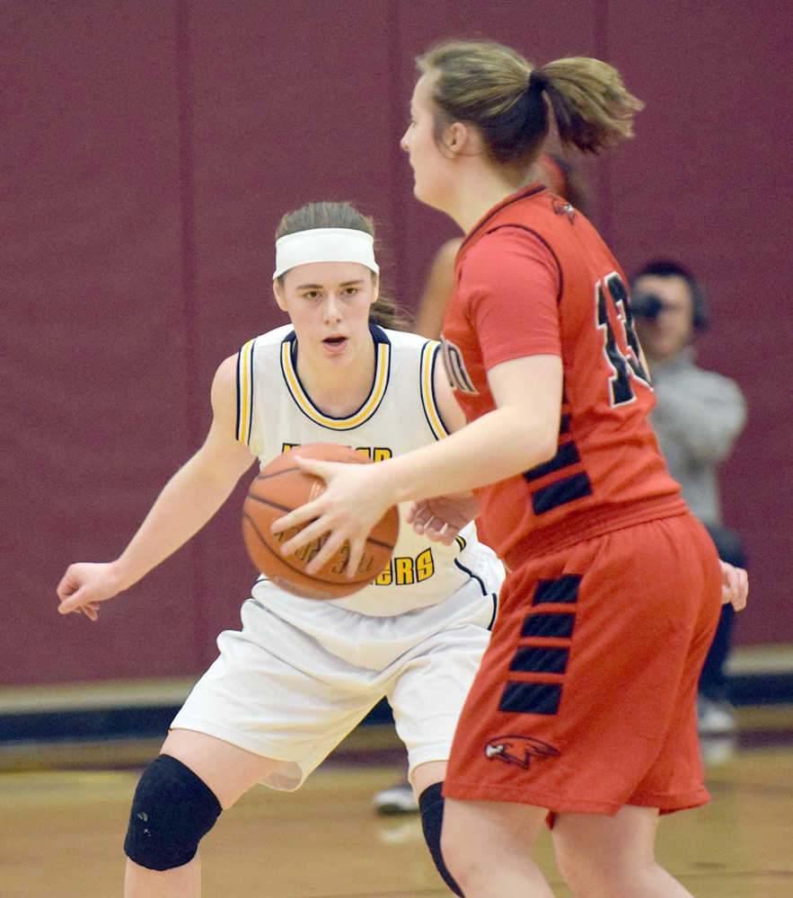 Photo by Joey Klecka/Peninsula Clarion Homer senior forward Madison Akers tracks the ball while defending Houston forward Aspen Ruth in Friday's semifinal game at the Southcentral Conference tournament at Grace Christian High School.