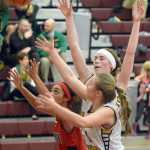 Photo by Joey Klecka/Peninsula Clarion Houston guard Chanel May-Thomas (left) and Homer forwards Madison Akers and Uliana Reutov battle for a rebound in Friday's semifinal contest at the Southcentral Conference tournament at Grace Christian High School.