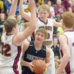 Photo by Joey Klecka/Peninsula Clarion Nikiski guard Ian Johnson (center) drives to the rim amid a trio of Grace Christian defenders Friday night at the Southcentral Conference tournament at Grace Christian High.