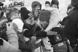 AliyZirkle, right, greets fans at the finish line of the Iditarod Trail Sled Dog Race, Tuesday, March 15,  2016, in Nome, Alaska. Zirkle finished third. (AP Photo/Mark Thiessen)