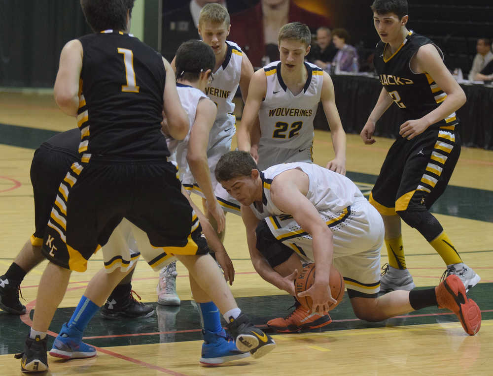 Photo by Joey Klecka/Peninsula Clarion Ninilchik senior Pat Brandt (center) fights for a loose ball Thursday against King Cove at the Class 1A March Madness state tournament at the Alaska Airlines Arena in Anchorage.