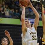 Photo by Joey Klecka/Peninsula Clarion Ninilchik forward Austin White (33) shoots amid a scrum of King Cove defenders Thursday at the Class 1A March Madness state tournament at the Alaska Airlines Arena in Anchorage.