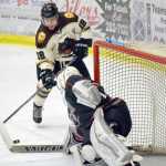 Photo by Jeff Helminiak/Peninsula Clarion Kenai River Brown Bears forward Collin Appleton drives the net, but is stopped by New Jersey Titans goalie Spencer Wright on Friday at the Soldotna Regional Sports Complex.