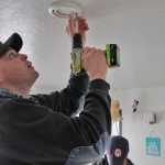 Lilac Lane resident Jared Clay (left) talks with Kenai Fire Marshal Tommy Carver about his apartment's smoke detectors and his family's fire escape on Saturday, March 19 in Kenai. Carver and other members of the Kenai Fire Department, along with volunteers from the American Red Cross, were going door-to-door Saturday to install free smoke detectors in homes.