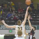 Photo by Joey Klecka/Peninsula Clarion Ninilchik junior Austin White (33) puts a block on Nikolaevsk junior Nikit Fefelov late in Saturday's Class 1A state championship boys game at the Alaska Airlines Center in Anchorage.