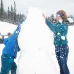 Dmitry Marlowe, 9, and Lydia Marlowe, 14, put the finishing touches on a snowman on Sunday, March 20, 2016 at the Kenai Golf Course in Kenai, Alaska. The first day of Spring found Kenai coated in a layer of wet, sticky snow after several days of sunshine.