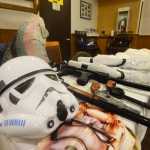 Photo by Megan Pacer/Peninsula Clarion Props ranging from a storm trooper mask to a stuffed fish named "Wappy" cover a table in preparation for a Triumvirate Theatre rehearsal on Tuesday, March 22, 2016 at Mykel's Restaurant in Soldotna, Alaska. The group will perform the latest of its annual dinner theatre and auction events, "Fish Wars: The Humpy Rises," beginning March 25.