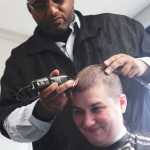 Barber Alexander Walton of Glacier City Barbershop shaves the head of Laura Best during the St. Baldrick's head-shaving fundraiser on Thursday, March 24 at Kenai Peninsula College. Best has shaved her head for the pediatric cancer research fundraiser three times since 2010, donating her hair to Locks of Love, a group that makes wigs for cancer patients.