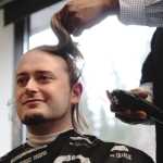A volunteer's head is shaved by barber Alexander Walton of Glacier City Barbershop during a St. Baldrick's Foundation head-shaving fundraiser on Thursday, March 24 at Kenai Peninsula College.