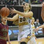 Photo by Joey Klecka/Peninsula Clarion Homer senior Aurora Waclawski (20) drives for a layup against Grace Christian defenders Mary Hogan (15) and Sarah Laker in Thursday's Class 3A girls state tournament quarterfinal round at the Alaska Airlines Center in Anchorage.