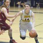Photo by Joey Klecka/Peninsula Clarion Homer senior Madison Akers works to shake loose Mt. Edgecumbe defender Payton Weisz in Friday's Class 3A state semifinal at the Alaska Airlines Center in Anchorage.