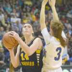 Photo by Joey Klecka/Peninsula Clarion Homer senior forward Madison Akers looks to the basket against Barrow defender Alaina Wolgemuth in Saturday's Class 3A girls state championship at the Alaska Airlines Center in Anchorage.