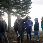 Photo by Megan Pacer/Peninsula Clarion Kenaitze Indian Tribe members, students and Kenai Peninsula College faculty make their way through the woods to the site of Kalifornsky Village on Thursday, March 24, 2016 off of Kalifornsky Beach Road in Alaska.