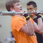 Photo by Jeff Helminiak/Peninsula Clarion Nikiski senior Dylan Broussard does a push press on the way to winning the Fight Gone Bad event at the Speed and Strength Training competition Wednesday at Nikiski High School.