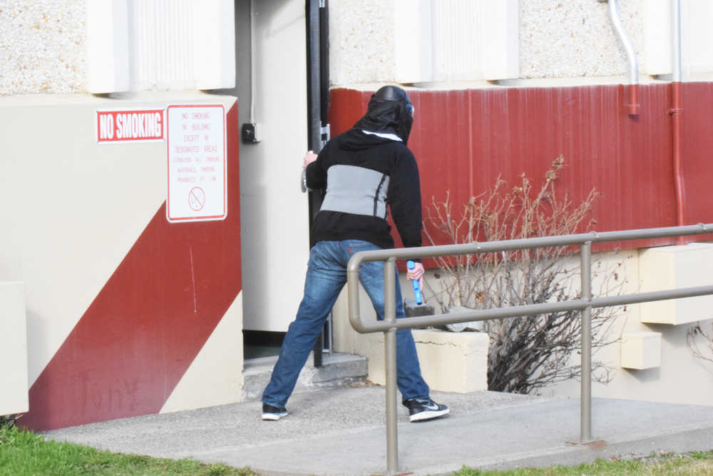 Photo by Megan Pacer/Peninsula Clarion Koebryn Mlynarik enters the Kenai Peninsula Borough building during an active shooter simulation as part of this year's Alaska Shield exercise on Thursday, March 31, 2016 in Soldotna, Alaska.