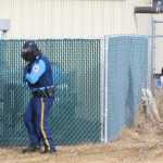 Photo by Megan Pacer/Peninsula Clarion An Alaska State Trooper and a Soldotna Police officer round a fence in preparation to pursue a simulated active shooter during an Alaska Shield exercise on Thursday, March 31, 2016 at the Kenai Peninsula Borough building in Soldotna, Alaska.