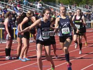 Photo by Joey Klecka/Peninsula Clarion Soldotna junior Daisy Nelson (728) hands off to Stars teammate Olivia Hutchings (719) in the girls 3,200-meter relay at the Class 4A state meet May 30, 2015. Hutchings and Nelson were joined by seniors Sadie Fox and Dani McCormick to set a new state record in the event.