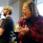 Audience members react to a story told by Bill Holt during a storytelling evening on Friday, April 1 at Odie's Deli.