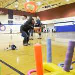 Jordan Tackett (left) plays a ring-toss game against her mother during the Autism Extravaganza awareness fair at Soldotna Preparatory School on Saturday, April 4. Tackett, who is autistic, was among those who came to play games and socialize during the event.