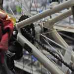 Photo by Elizabeth Earl/Peninsula Clarion Brad Carver of Beemun's Bike and Ski Loft lubes a bike chain as part of a spring tune-up on Tuesday, March 29, 2016.