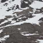 Photo by Joey Klecka/Peninsula Clarion A hiker (bottom right) descends the snowy, rocky traverse on the upper slopes of Skyline peak on April 1.