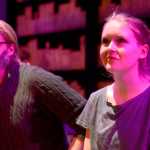 The Giver (Logan Schoessler, left) watches Joan (Kayla Haeg) react to her first experience of a sunset during a performance of "The Giver," based on the young adult novel by Lois Lowry, on Wednesday, April 6 at Solodotna High School.