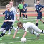 Photo by Joey Klecka/Peninsula Clarion Homer sophomore Charles Rohr (2) wins a battle for the ball over Kenai freshman Connor Felchle in a regular season matchup Wednesday evening at Kenai Central High School.