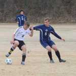 Photo by Rashah McChesney/Peninsula Clarion Nikiski midfielder Nathan Carstens (6) puts a move on Homer's Filip Reutov (5) on May 9, 2015 at Nikiski High School.