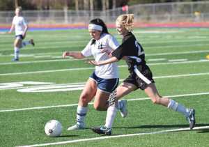 Photo by Joey Klecka/Peninsula Clarion Soldotna's Sarah Federle (left) battles for the ball against Nikiski's Molly Cason Tuesday at Soldotna High School.
