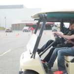 Photo by Megan Pacer/Peninsula Clarion Sophie Crawford finishes driving through an obstacle course while wearing vision-impairing goggles under the supervision of Kenai Police Officer Alex Prins during an exercise Wednesday, April 13, 2016 at Kenai Central High School in Kenai, Alaska. Students completed the driving drill as part of a unit in their health class.