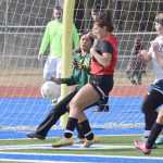 Photo by Jeff Helminiak/Peninsula Clarion Kenai Central's Sarah Every (center) tries to strike the ball in front of Marlayna Saavedra before the ball rolls just wide of the goal Thursday at Soldtona High School.