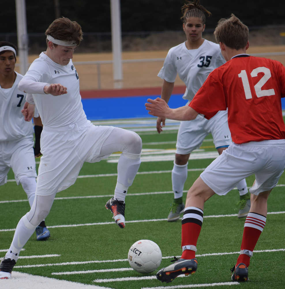 Photo by Jeff Helminiak/Peninsula Clarion Soldotna's Ben Godfrey makes a move on Kenai Central's Ean Atchley on Thursday at Soldotna High School.