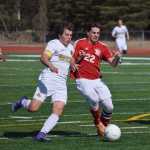 Photo by Joey Klecka/Peninsula Clarion Kenai Central defender Max Dye (22) battles with South Anchorage's Blake Hepler Saturday afternoon at Ed Hollier Field in Kenai.