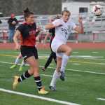 Photo by Joey Klecka/Peninsula Clarion Kenai Central defender Sarah Every (left) eyes the ball along with South Anchorage's Isabel Evans Saturday at Ed Hollier Field in Kenai.