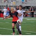 Photo by Joey Klecka/Peninsula Clarion Kenai Central sweeper Kylie Morse (left) battles for the ball with South Anchorage's Alex Ott Saturday afternoon at Ed Hollier Field in Kenai.