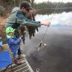 Photo by Kelly Sullivan/ Peninsula Clarion (Not pictured) Aimee, (left) Rudy and Sam Zulkanycz get in some early spring fishing Monday, April 18, 2016, at Loon Lake in Soldotna, Alaska. Sam said the quiet spot is a family favorite, especially when the sun is out and there is no one else on the joining them on the perimeter. "They aren't the biggest and best fish by that's okay," he said.