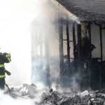 Members of the Kenai Fire Department finish putting out a shed fire Thursday, April 21, 2016 on North Dogwood Road in Kenai. The fire, which took about a half hour to extinguish, burnt two sheds, a chicken coop and the outside of a home, but harmed no one.