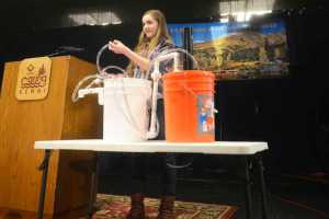 Photo by Megan Pacer/Peninsula Clarion Freshman Victoria Giles from Soldotna Prep demonstrates her project that converts organic matter into energy before a panel of judges for this year's Caring for the Kenai oral presentations Thursday, April 21, 2016 at Kenai Central High School in Kenai, Alaska. From more than 300 applicants, 12 students were chosen to present their projects in a final round, after which six runners up won fixed prizes and another six won prizes varying from $550-$1,600.
