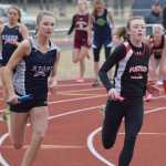 Photo by Joey Klecka/Peninsula Clarion Soldotna senior Daisy Nelson (left) and Kenai Central sophomore Melia Harding duke it out on the final leg of the girls 800-meter relay Saturday afternoon at Kenai Central High School.