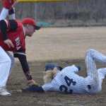 Photo by Joey Klecka/Peninsula Clarion Soldotna senior Kenny Griffin (24) steals third base just before Kenai Central third baseman Connor Jones tags him Tuesday at the Soldotna ball fields.
