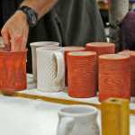 Photo by Elizabeth Earl/Peninsula Clarion Bryan Olds of Kenai prepares his pottery mugs to be fired in the kiln at the Fine Arts Building in Kenai on Friday, April 15, 2016. The pottery studio, the only cooperative one in the state, has been operating for about 42 years.