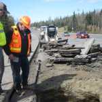 Alaska Department of Transportation Station Manager Brian Gabriel, right, and Marcus Forkner, project engineer for DOT, assess a pothole leading to an approximately 15-foot long sinkhole under the Kenai Spur Highway on Wednesday, April 27, 2016 in Kenai, Alaska. Authorities blocked off a portion of the northbound lanes of the highway after motorists reported the pothole. The Department of Transportation will fill the sinkhole, and the road was already scheduled to be repaved this summer.