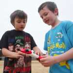 Photo by Kelly Sullivan/ Peninsula Clarion Xander Withrow and Malachi Kirby wind up the string of their kite, which was they were having trouble getting off the ground Thursday, April 28, 2016, at Kalifornsky Beach Elementary, in Soldotna, Alaska.