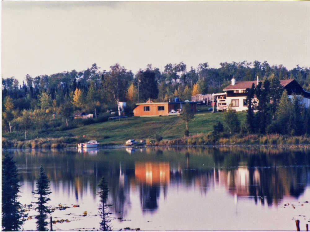 Photo courtesy Mullican family The Mullican family built the original brick house (left) when they arrived on their homestead on Sevena Lake in the 1960s, and Clyde and Roseanna Mullican built the bigger house (right) after they retired.