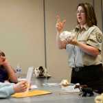 Kenai National Wildlife Refuge Park Ranger Leah Eskelin explains the features of an animal skull to a group of Girl Scouts during the Women of Science event on Saturday, April 30 at Kenai Peninsula College.