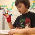 Photo by Kelly Sullivan/ Peninsula Clarion  First grader Xander Withrow reads his Ladybug Important Poem Thursday, April 28, 2016, at Kalifornsky Beach Elementary, in Soldotna, Alaska.