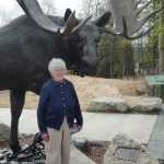 Marge Mullen - homesteader, community builder, and conservationist - in front of "Majesty of the Kenai" at the Kenai National Wildlife Refuge Visitor Center. (Photo by Walter Ward)