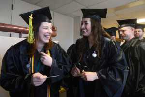 Photo by Megan Pacer/Peninsula Clarion Soldotna residents Cassandra Boze, left, and Becca Satathite share a laugh just before their graduation ceremony on Thursday, May 5, 2016 in the Renee C. Henderson Auditorium at Kenai Central High School in Kenai, Alaska. Boze graduated with a Associate Degree of Appied Science in Nursing, and Satathite with an Associate Degree of Applied Science in Paramedic Technology.
