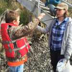 Photo by Megan Pacer/Peninsula Clarion Chris Bessette, a third grader from Soldotna Elementary, shows off the trash he found to Soldotna Elementary teacher Shaya Straw during this year's Kenai River Spring Cleanup event on Friday, May 6, 2016 at Soldotna Creek Park in Soldotna, Alaska. More than 600 kids combed the riverbanks in several locations on the central Kenai Peninsula, competing for prizes and learning about good stewardship.